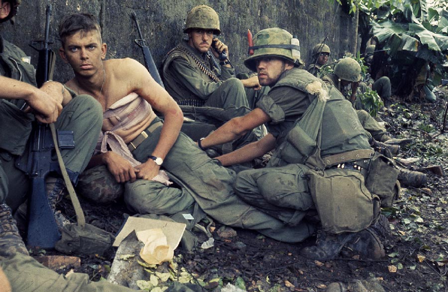 soldiers in battle, one is injured