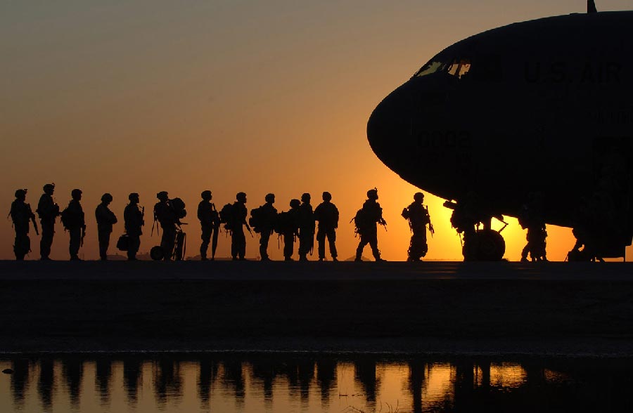 soldiers getting on a plane